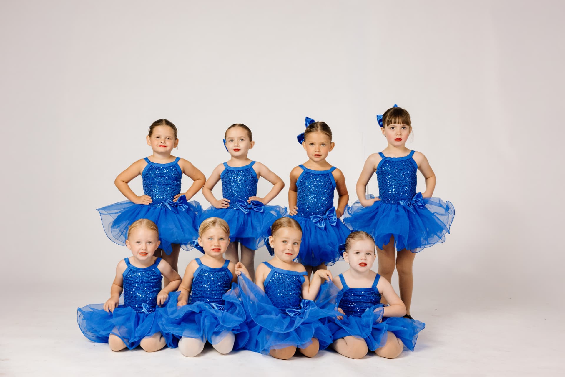 IMPACT young dancers in blue sequin tutus posing for a studio portrait